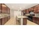This open kitchen has beautiful granite countertops, and a large island with seating, and stainless steel appliances at 17440 Hampton Falls Ter, Bradenton, FL 34202