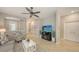 Comfortable living room with tile flooring, a cozy sofa, a TV, and a view of the entryway, perfect for relaxation at 17440 Hampton Falls Ter, Bradenton, FL 34202