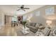 Open-concept living room with tile flooring, a comfortable sofa, and views of the kitchen and dining area at 17440 Hampton Falls Ter, Bradenton, FL 34202