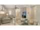 Open concept floor plan with high ceilings and lots of natural light, showcasing both living and dining spaces at 17440 Hampton Falls Ter, Bradenton, FL 34202