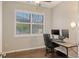 Office space featuring a large window, desk with multiple monitors, and hardwood flooring at 17440 Hampton Falls Ter, Bradenton, FL 34202