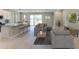Spacious living area provides an open layout with a clear view of the kitchen and outdoor patio at 17727 Pastureland Ave, Lakewood Ranch, FL 34211