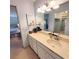 Bathroom featuring a vanity with countertop, a large mirror, and a peek to the bedroom at 182 Pineneedle Dr # 182, Bradenton, FL 34210