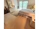 Bedroom with carpet, white walls and furniture, and a view to the screened lanai at 182 Pineneedle Dr # 182, Bradenton, FL 34210