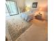 Comfortable bedroom featuring carpet flooring, neutral walls and a large sliding closet at 182 Pineneedle Dr # 182, Bradenton, FL 34210