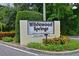 Entrance to Wildewood Springs community with lush landscaping, creating a welcoming atmosphere at 182 Pineneedle Dr # 182, Bradenton, FL 34210