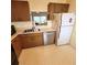 A full kitchen includes an oven, microwave, dishwasher, and refrigerator at 182 Pineneedle Dr # 182, Bradenton, FL 34210