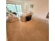 Comfortable living room with floral sofa and sliding glass doors to sunroom at 182 Pineneedle Dr # 182, Bradenton, FL 34210