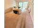 Comfortable living room with floral sofa and sliding glass doors to sunroom at 182 Pineneedle Dr # 182, Bradenton, FL 34210