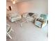 Inviting living room with floral-patterned sofas, light-colored walls, and a glass coffee table creates an airy, comfortable space at 182 Pineneedle Dr # 182, Bradenton, FL 34210