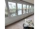 Sunroom with a wall of windows overlooking the backyard pond, bringing the beauty of the outdoors inside at 182 Pineneedle Dr # 182, Bradenton, FL 34210