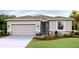 Charming single-story home featuring a two-car garage, stone accents and well-manicured landscaping at 18224 Metado Dr, Lakewood Ranch, FL 34211