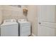 Bright laundry room equipped with washer and dryer, and ample shelving at 18224 Metado Dr, Lakewood Ranch, FL 34211