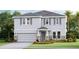Inviting two-story home featuring a stone-accented garage, gray siding and a well manicured lawn at 18312 Thistleberry Pl, Lakewood Ranch, FL 34211