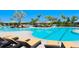 Resort-style pool with lush landscaping and plenty of lounge chairs for relaxation at 18320 Thistleberry Pl, Lakewood Ranch, FL 34211