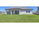 View of the backyard featuring a well-maintained lawn and a covered patio at 2015 Bolsena St, Nokomis, FL 34275