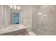 Modern bathroom featuring a glass shower, a new vanity, and chrome fixtures at 2015 Bolsena St, Nokomis, FL 34275