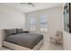 A bright bedroom with a comfortable bed, accent chair, and natural light at 2015 Bolsena St, Nokomis, FL 34275