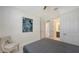 Bright bedroom featuring a comfortable bed, chair, and stylish art piece at 2015 Bolsena St, Nokomis, FL 34275