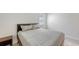 Bright bedroom featuring a comfortable bed, stylish nightstand, and natural light from a window at 2015 Bolsena St, Nokomis, FL 34275