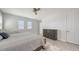 Well-lit bedroom with two windows, neutral decor, and view of the closet and the main bathroom at 2015 Bolsena St, Nokomis, FL 34275