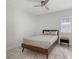 Cozy bedroom with ceiling fan, natural light, and a wooden bed frame and end table at 2015 Bolsena St, Nokomis, FL 34275