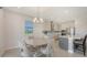 Bright and airy dining area featuring modern light fixtures, stainless steel appliances, and counter seating at 2015 Bolsena St, Nokomis, FL 34275