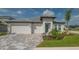 Inviting single-Gathering home with a three-car garage, manicured lawn, and elegant gray roof at 2015 Bolsena St, Nokomis, FL 34275