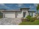Beautiful single-story home with a three-car garage, modern architecture and a well-manicured lawn at 2015 Bolsena St, Nokomis, FL 34275
