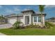 Welcoming single-story home with manicured front yard and a spacious three-car garage at 2015 Bolsena St, Nokomis, FL 34275
