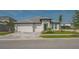 Charming single-story home with a three-car garage, clean lines, and a meticulously kept front yard at 2015 Bolsena St, Nokomis, FL 34275