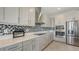 Beautiful kitchen featuring stainless steel appliances and stylish backsplash at 2015 Bolsena St, Nokomis, FL 34275