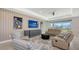 A spacious living room with neutral tones, modern furnishings, and a view of the backyard at 2015 Bolsena St, Nokomis, FL 34275