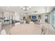 Open-concept living room featuring a gourmet kitchen, dining area, and comfortable seating at 2015 Bolsena St, Nokomis, FL 34275