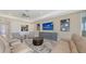 Bright and inviting living room with comfortable seating, modern decor, and a ceiling fan at 2015 Bolsena St, Nokomis, FL 34275