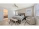 Comfortable main bedroom featuring a ceiling fan, natural light, and an en-suite bathroom at 2015 Bolsena St, Nokomis, FL 34275