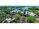 An aerial shot showing a charming clubhouse surrounded by palm trees and a beautiful lake at 205 Shell Creek Ct, Apollo Beach, FL 33572