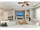 Comfortable living room featuring a stone accent wall, a ceiling fan, and a modern television at 205 Shell Creek Ct, Apollo Beach, FL 33572