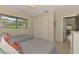 Bright bedroom with two twin beds, natural light from the window and closet with bi-fold doors at 2105 Hibiscus St, Sarasota, FL 34239