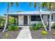 Inviting front entrance with modern door, stylish landscaping, and contemporary design elements at 2105 Hibiscus St, Sarasota, FL 34239