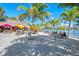 Vibrant waterfront restaurant with shaded outdoor seating under colorful umbrellas and palm trees at 2105 Hibiscus St, Sarasota, FL 34239