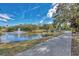 Scenic view of a community pond with a fountain, walking path, and lush landscaping on a bright sunny day at 2105 Hibiscus St, Sarasota, FL 34239