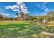 Expansive green lawn with picturesque community pond featuring a fountain, bridge, and lush trees on a bright sunny day at 2105 Hibiscus St, Sarasota, FL 34239