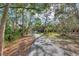 Winding community walking path through mature trees offers residents a serene escape into nature at 2105 Hibiscus St, Sarasota, FL 34239