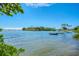 Serene waterfront view featuring calm blue water, moored boats, lush greenery, and clear skies on a sunny day at 2105 Hibiscus St, Sarasota, FL 34239