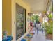 Inviting front porch setting with comfortable seating and charming decor at 2239 Circlewood Dr # 17, Sarasota, FL 34231