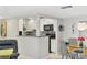 Open concept kitchen with granite countertops, stainless steel appliances, and stylish mosaic backsplash at 2239 Circlewood Dr # 17, Sarasota, FL 34231