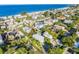 Aerial view of a charming coastal community and home near a sandy beach and blue ocean waters at 2300 Avenue B, Bradenton Beach, FL 34217