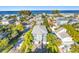 Beautiful aerial view of a two-story home near the ocean with lush green landscaping and a grey roof at 2300 Avenue B, Bradenton Beach, FL 34217