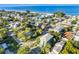 Beautiful aerial view of a coastal community and home near a sandy beach and blue ocean waters at 2300 Avenue B, Bradenton Beach, FL 34217